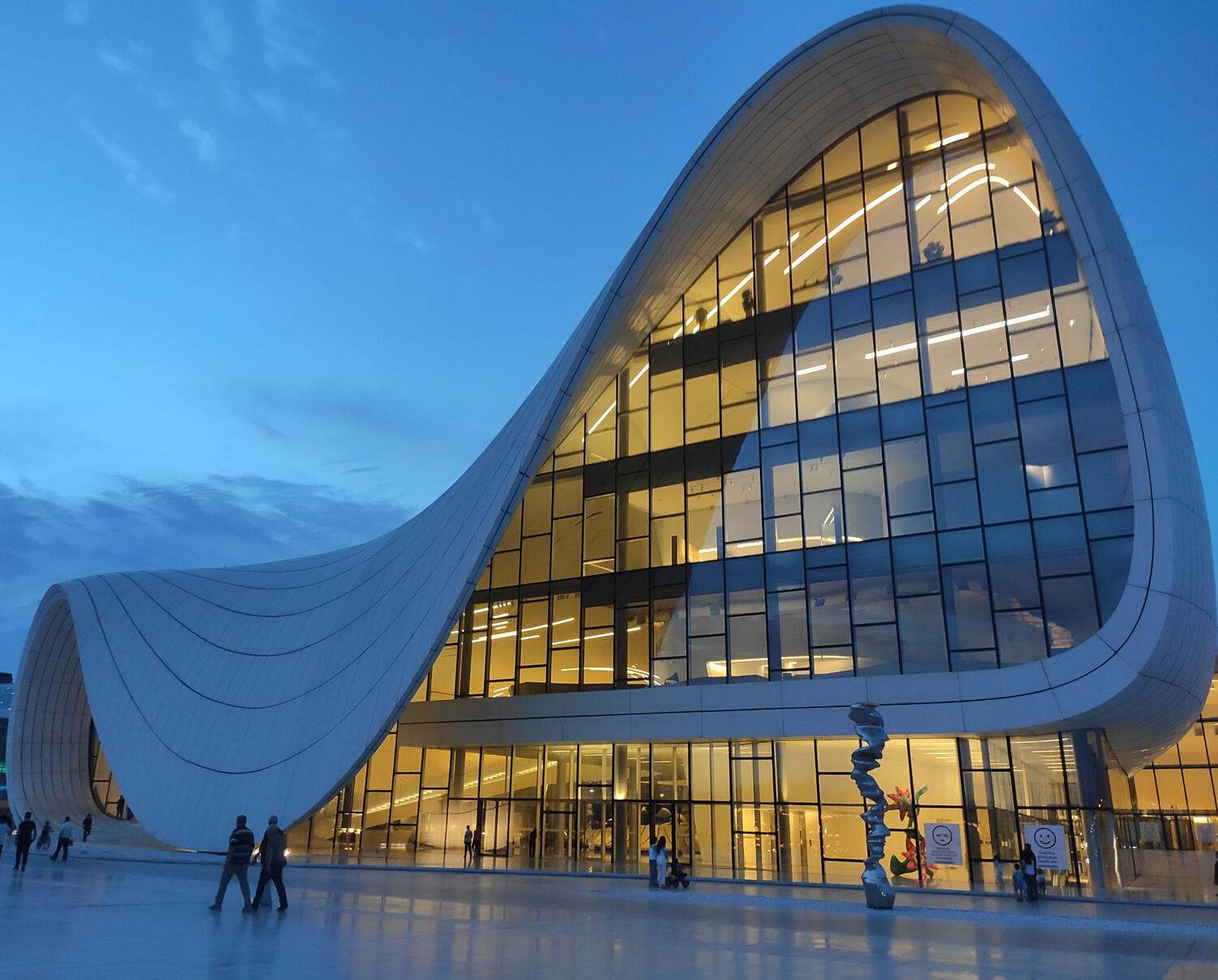 Heydar Aliyev Centre by Zaha Hadid at twilight, lit from inside, by paid media consulting agency Criterion Global